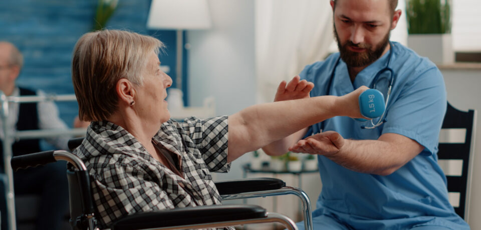 physiotherapy for elderly patient doing guided exercises with therapist
