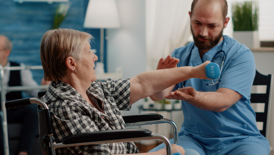 physiotherapy for elderly patient doing guided exercises with therapist